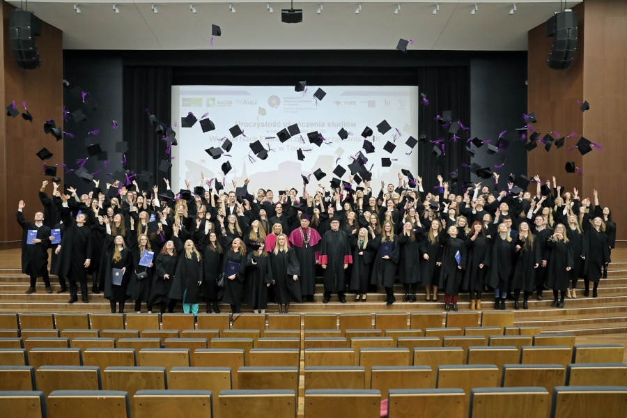 Alumni with Faculty's Deans at NCU Auditorium throwing birettas