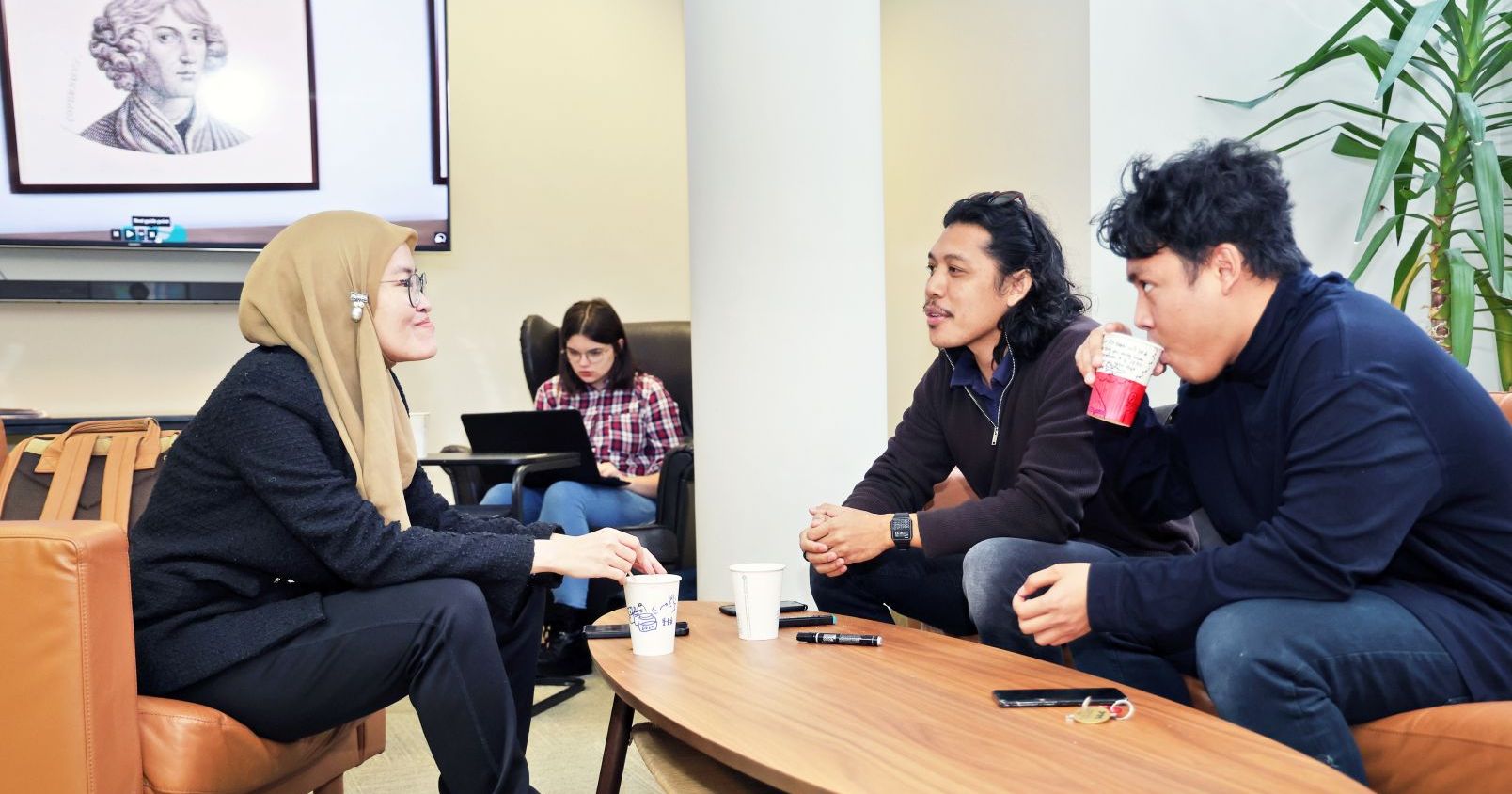 inyternational students sitting arround the table
