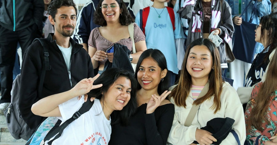 A group of foreign students posing for picture