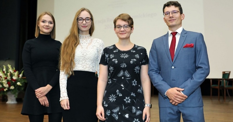 in the photo there are four people dressed in gala clothes, three women and a man