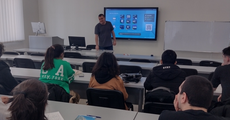 Jacek Wełniak, MA is teaching classes. Students are facing him in the classroom