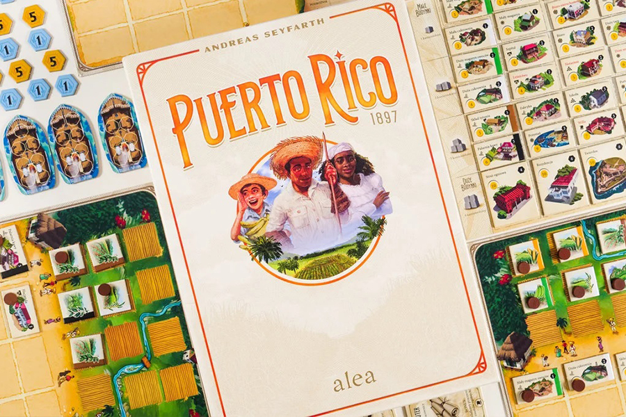 na zdjęciu okładka gry planszowej Puerto Rico 1897 oraz komponenty z gry