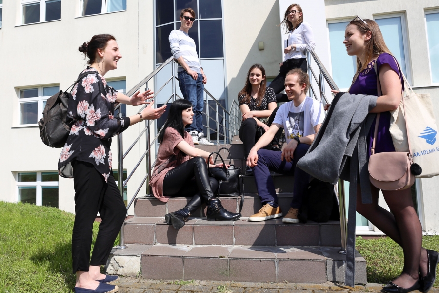 Grupa studentów siedząca na schodach przed WNBIW