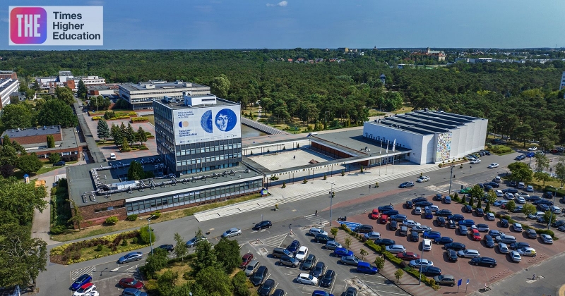 Kampus UMK widziany z lotu ptaka. W lewym górnym rogu wstawione jest logo Times Higher Education