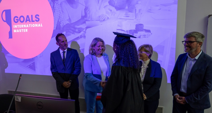 Awarding diplomas. Few people standing