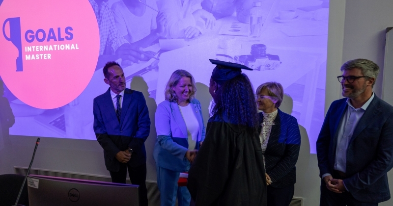 Awarding diplomas. Few people standing