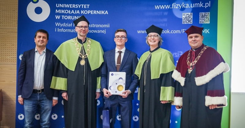Władze Uczelni, Wydziału i Instytutu Fizyki z laureatem tytułu najlepszego absolwenta pozują do zdjęcia