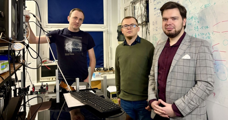 Trzech mężczyzn stoi i patrzy w obiektyw. To fizycy: dr hab. Piotr Kolenderski, prof. UMK, dr Artur Czerwiński i mgr Jakub Borkowski