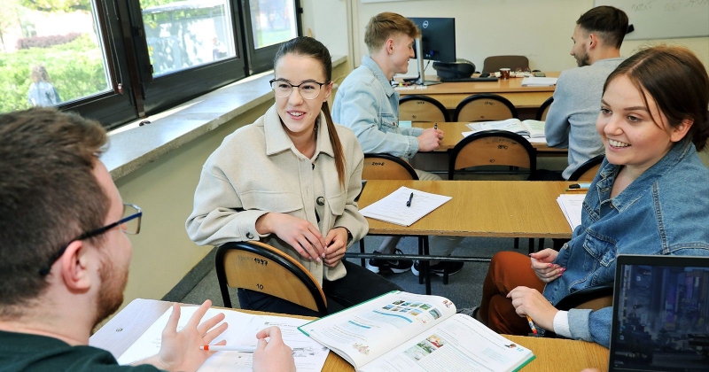 Bunch of students during the class, talking to each other